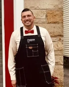 John Chapman in his The Shop apron and red bow tie